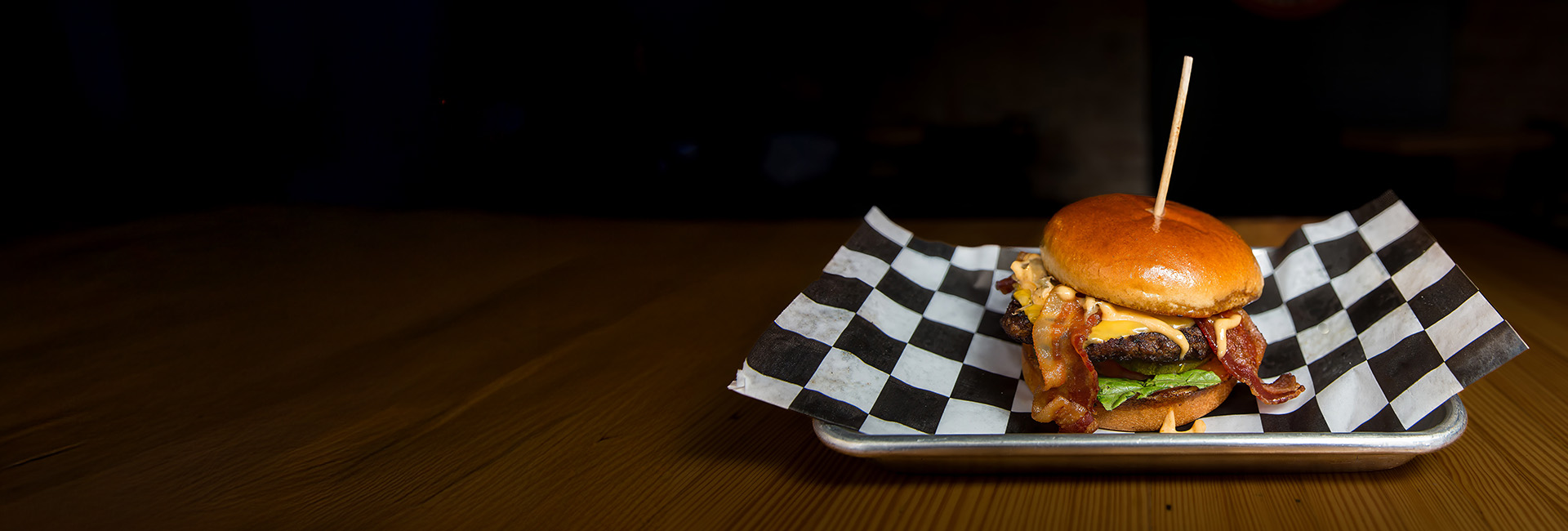 Bacon cheeseburger served on a platter.