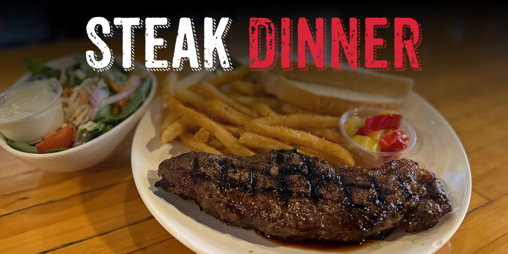Sirloin steak dinner with fries and a side salad.