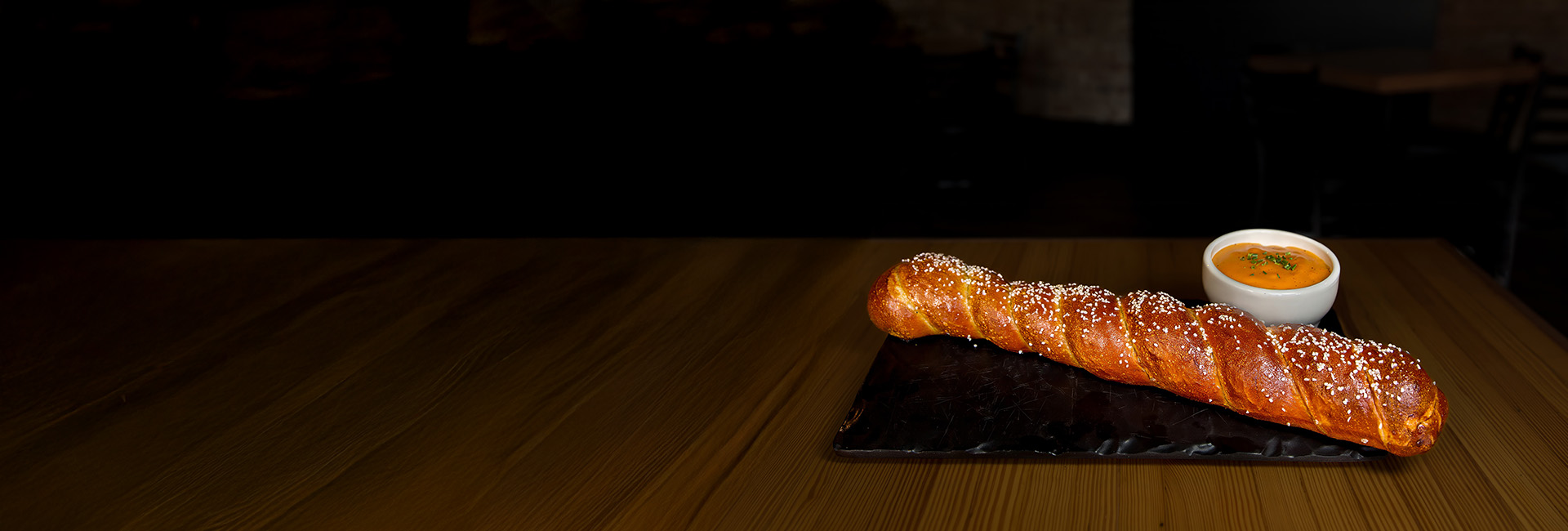 Big soft pretzel served with cheese dipping sauce.