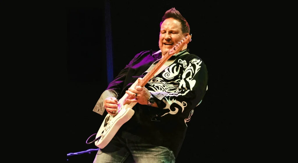 Rajma playing guitar.